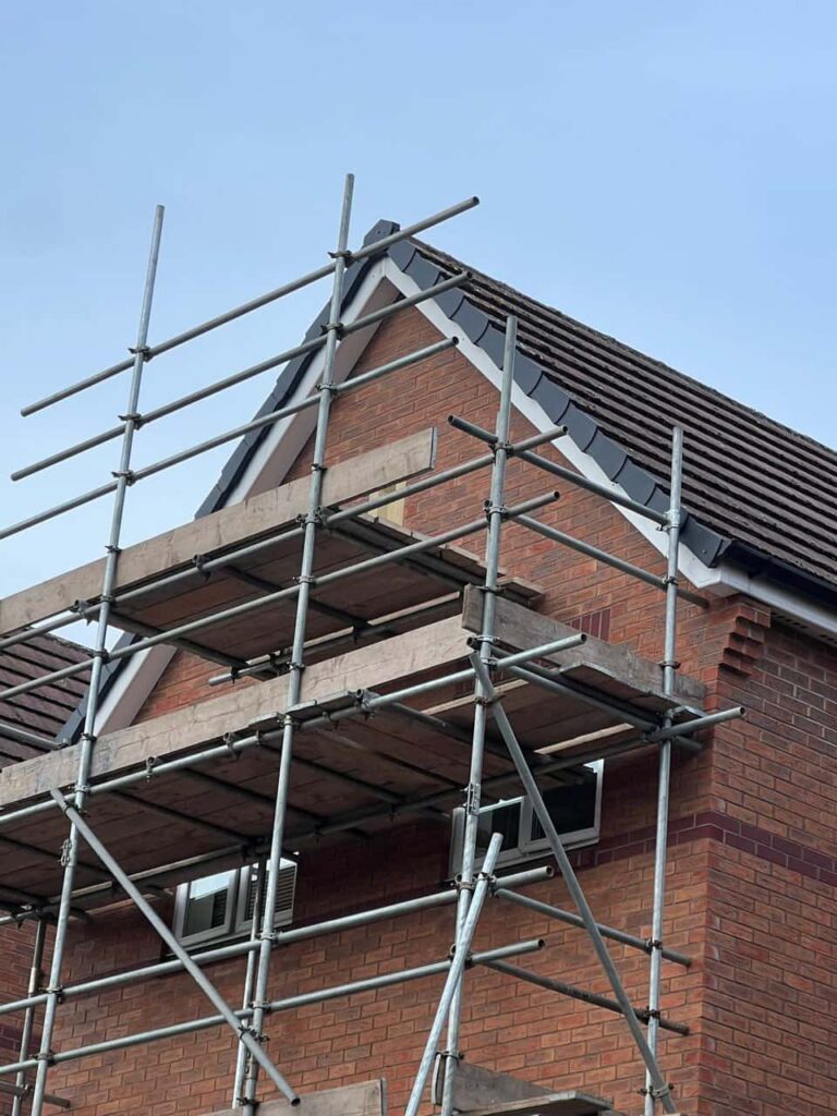 This is a photo of a roof which has just been repaired. There is a scaffold located at the gable end for access onto the roof. Works carried out by Tuxford Roofing Repairs