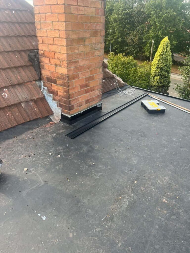 This is a photo of a flat roof which has just been repaired, there is also a chimney stack and some leadwork has also been dressed. Works carried out by Tuxford Roofing Repairs